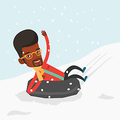 Image showing Man sledding on snow rubber tube in mountains.