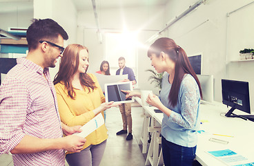 Image showing creative team with tablet pc talking at office