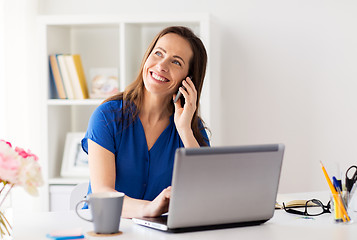 Image showing woman calling on smartphone at office or home