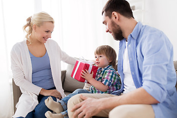 Image showing happy family with birthday gift at home