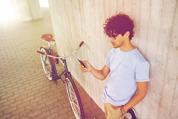 Image showing man with smartphone and fixed gear bike on street