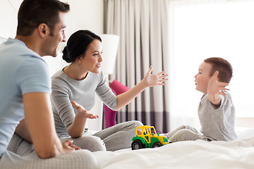 Image showing happy family in bed at home or hotel room