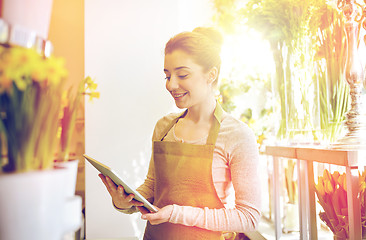 Image showing woman with tablet pc computer at flower shop