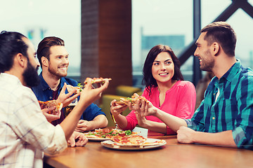 Image showing friends eating pizza with beer at restaurant