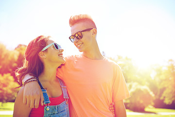 Image showing happy teenage couple looking at each other in park