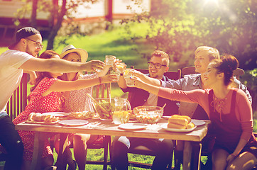 Image showing happy friends having dinner at summer garden party