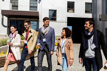 Image showing people with coffee and conference badges in city