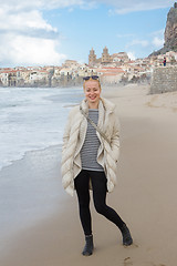 Image showing Woman on empty beach of Cefalu in winter time, Sicily, south Italy.