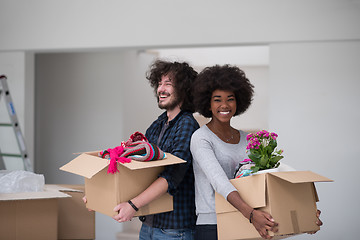 Image showing multiethnic couple moving into a new home