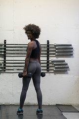 Image showing black woman doing bicep curls