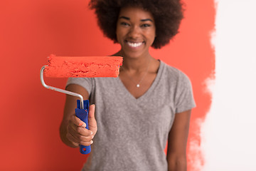 Image showing black woman painting wall