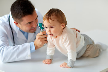 Image showing doctor with otoscope checking baby ear at clinic