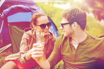 Image showing happy couple clinking drinks at campsite tent