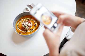 Image showing woman with smartphone photographing food at cafe