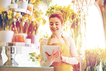 Image showing woman with tablet pc computer at flower shop