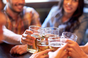 Image showing happy friends drinking beer at bar or pub