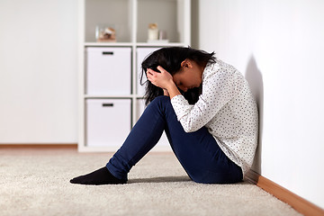 Image showing unhappy woman crying on floor at home