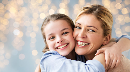 Image showing happy family of girl and mother hugging