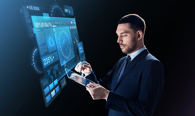 Image showing businessman in suit with transparent tablet pc