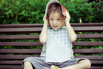 Image showing happy little boy sitting on bench