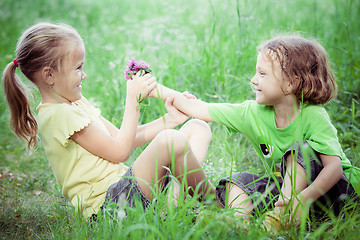 Image showing Two happy children  playing near the tree at the day time.