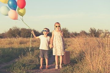 Image showing Happy children playing on the road at the day time.