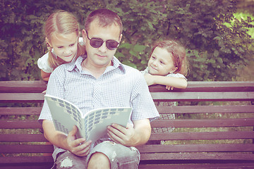 Image showing Father and children playing on the bench at the day time.