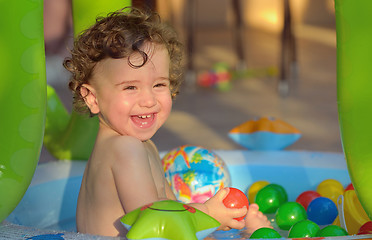 Image showing Laughing little girl swimming in the pool 