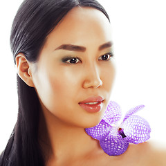 Image showing young pretty asian woman with flower purple orchid closeup isola