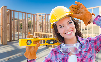 Image showing Female Construction Worker Holding Level Wearing Gloves, Hard Ha