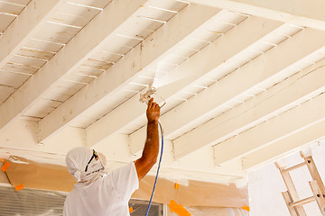 Image showing Professional House Painter Wearing Facial Protection Spray Paint