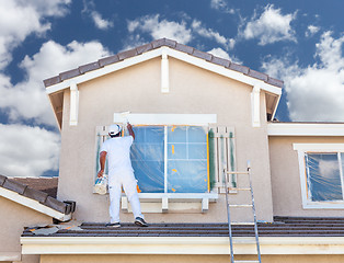 Image showing Professional House Painter Painting the Trim And Shutters of A H