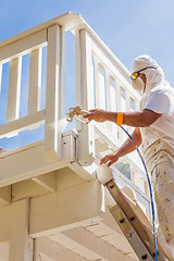 Image showing Professional House Painter Wearing Facial Protection Spray Paint