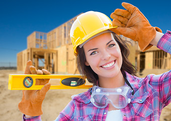 Image showing Female Construction Worker Holding Level Wearing Gloves, Hard Ha