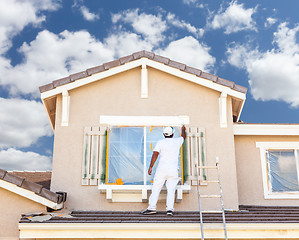 Image showing Professional House Painter Painting the Trim And Shutters of A H