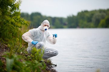 Image showing Chemist in respirator with bulb