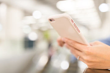 Image showing Woman using cellphone in a station