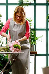Image showing Young florist in flower shop