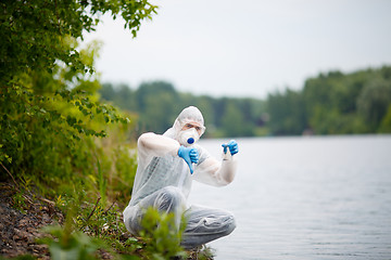 Image showing Biologist in respirator with bulb