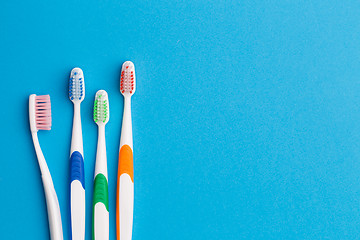 Image showing Multi-colored toothbrushes, space for text