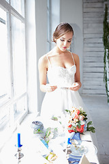 Image showing Beautiful bride in wedding dress, white background