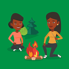 Image showing Two friends sitting around bonfire in camping.