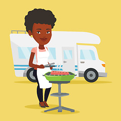 Image showing Woman having barbecue in front of camper van.