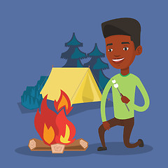 Image showing Man roasting marshmallow over campfire.