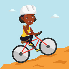 Image showing Young woman on bicycle traveling in the mountains.