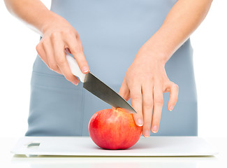 Image showing Cook is chopping apple