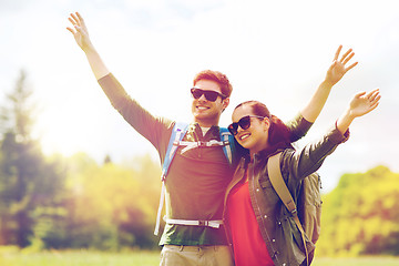 Image showing happy couple with backpacks hiking outdoors