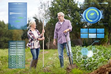 Image showing senior couple with shovels at garden or farm