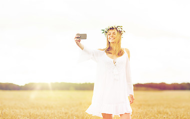 Image showing happy young woman taking selfie by smartphone