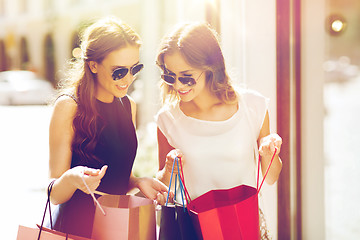 Image showing happy women with shopping bags in city